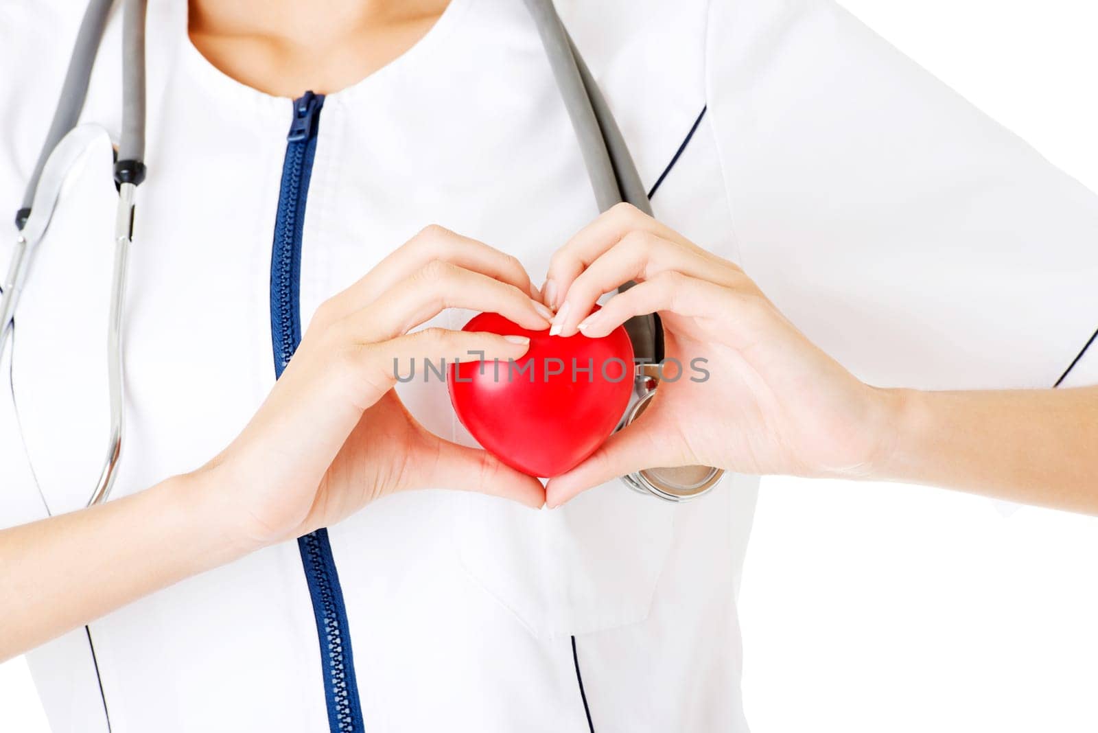 Young nurse with heart in her hand , isolated on white.