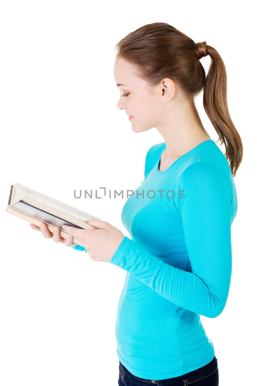 Young woman reading an old book, isolated on white