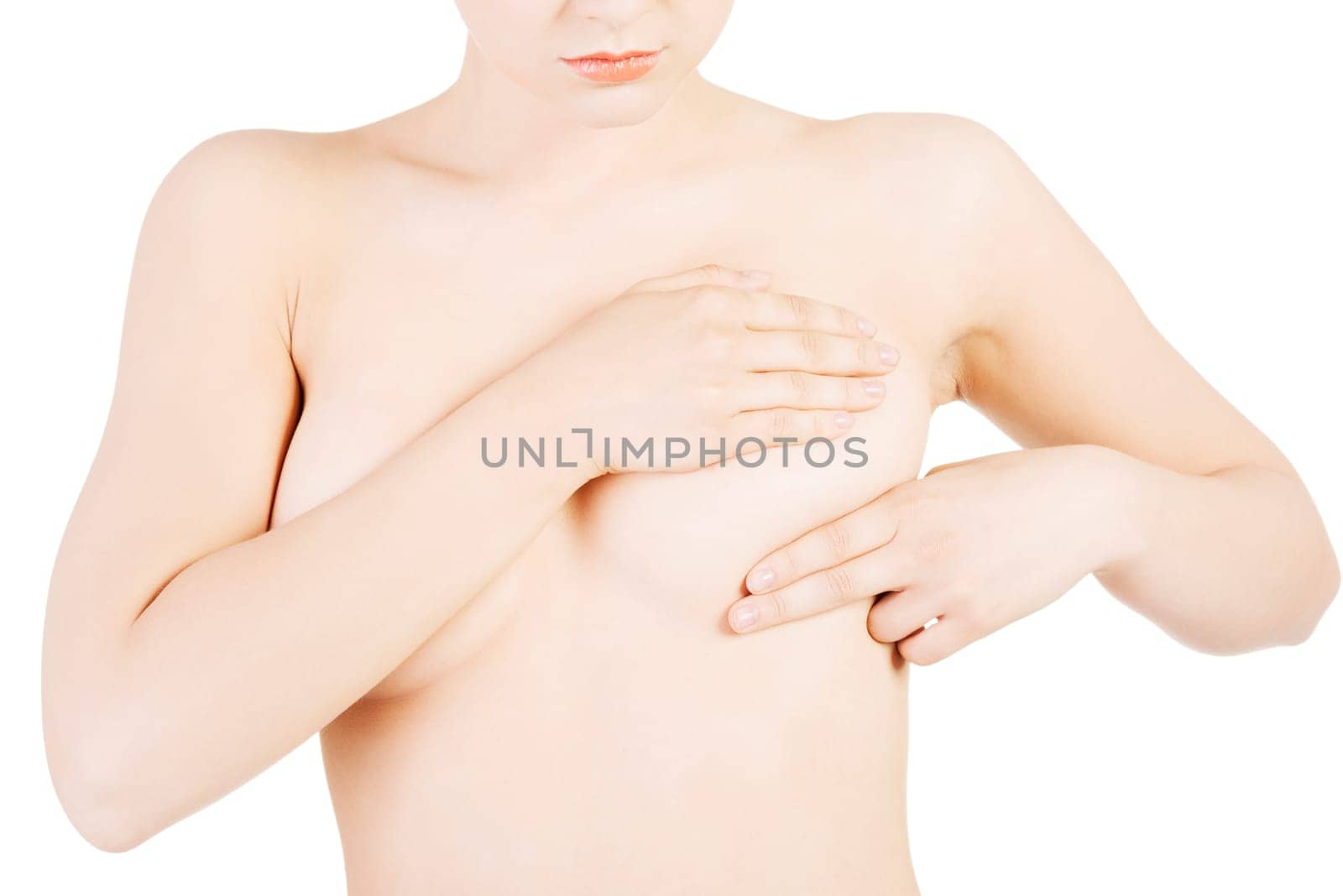 Caucasian adult woman examining her breast for lumps or signs of breast cancer
