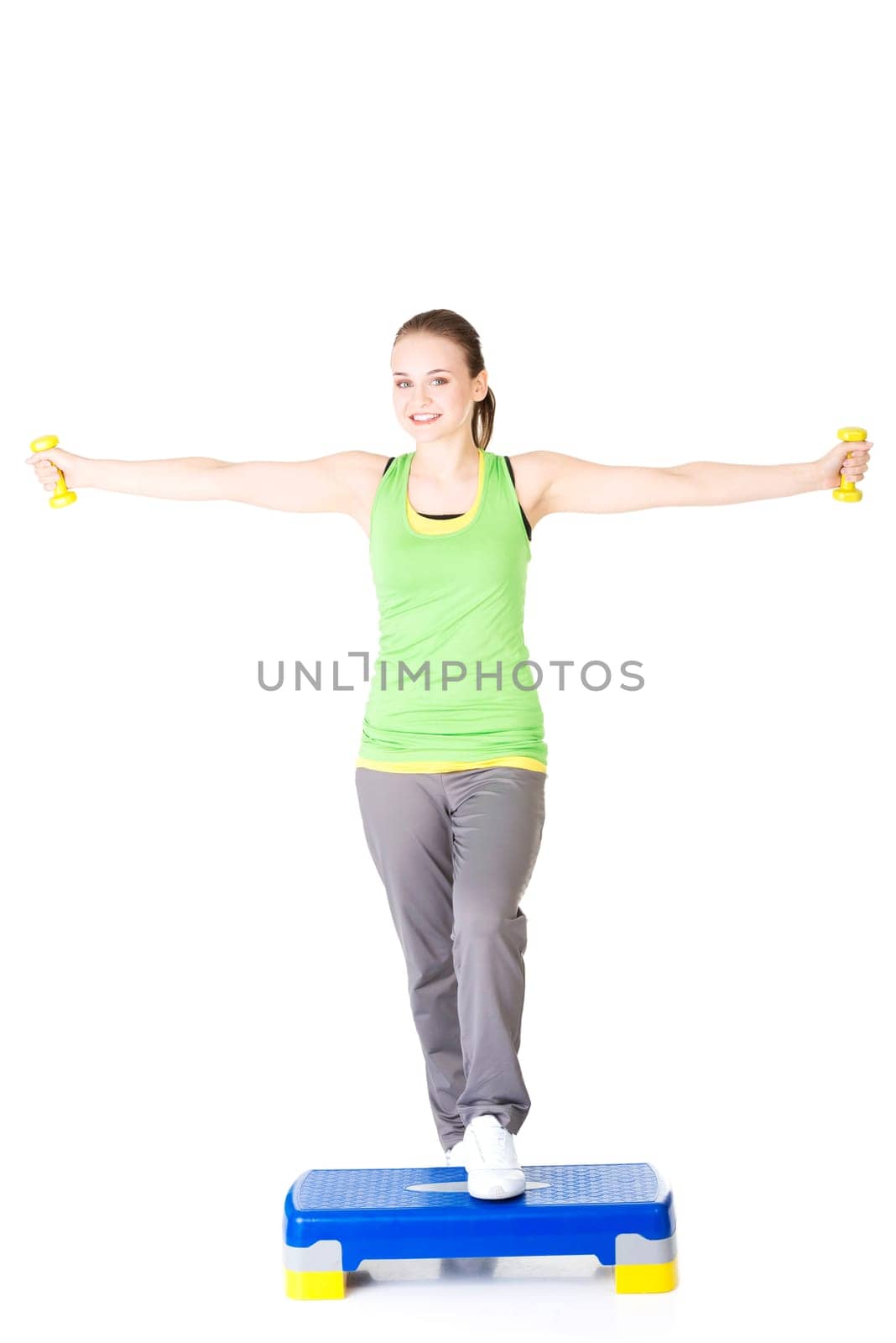 Fitness girl is working out with stepper , isolated on white background