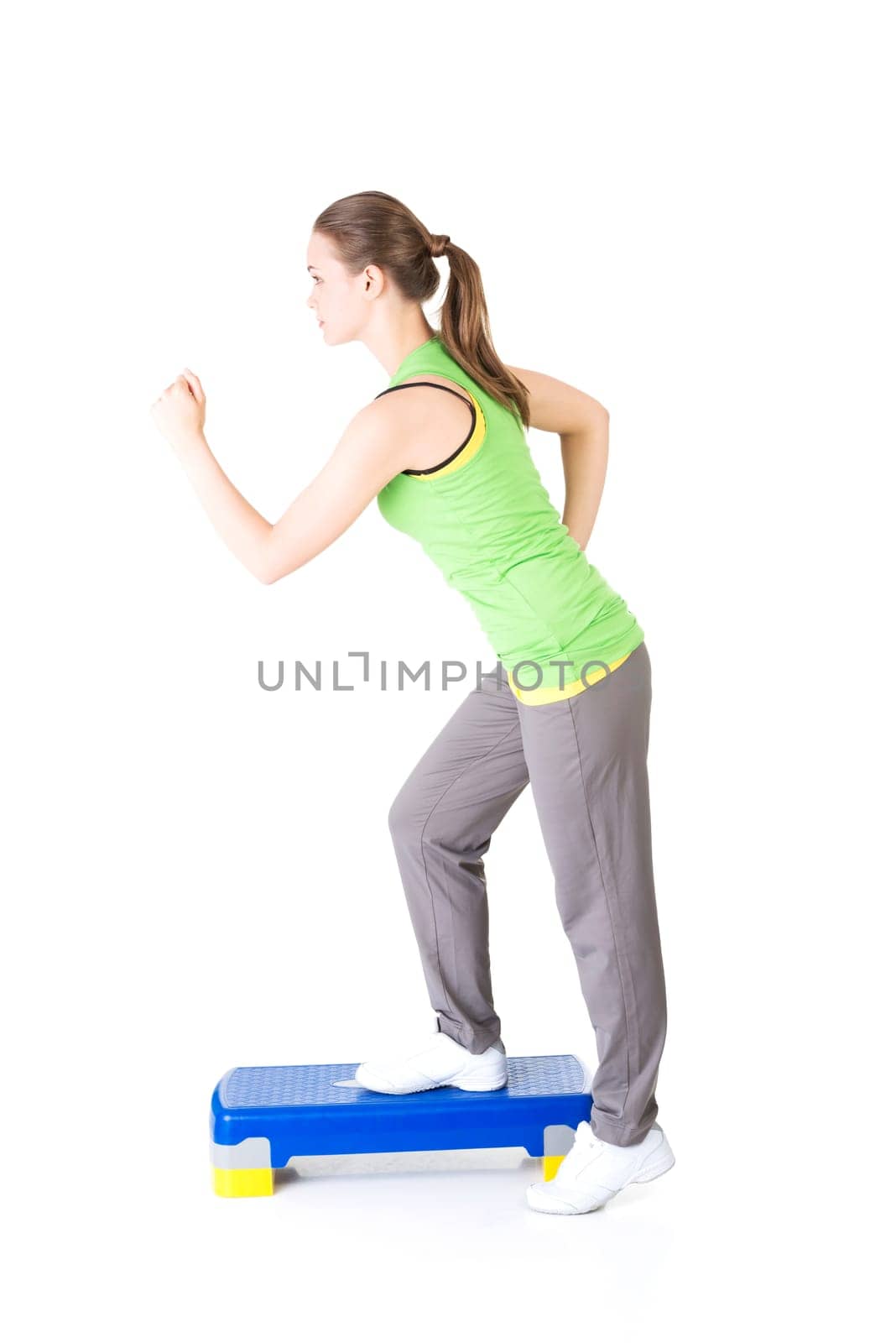 Fitness girl is working out with stepper , isolated on white background