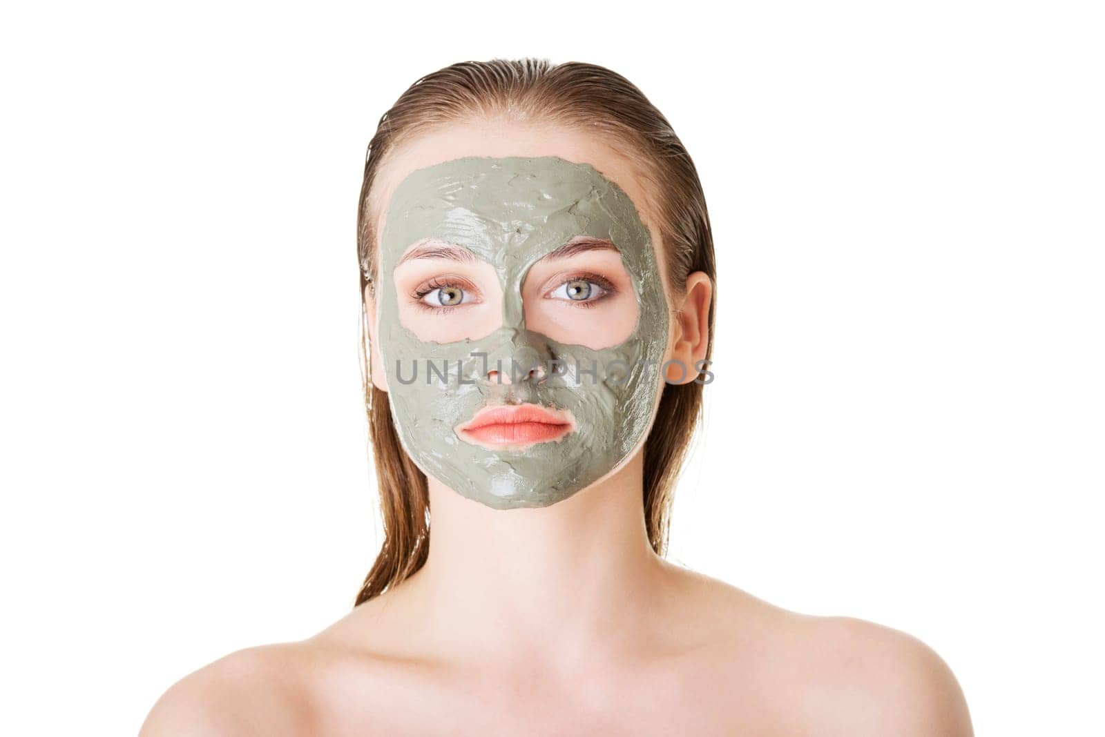 Beautiful woman with green clay facial mask, isolated on white