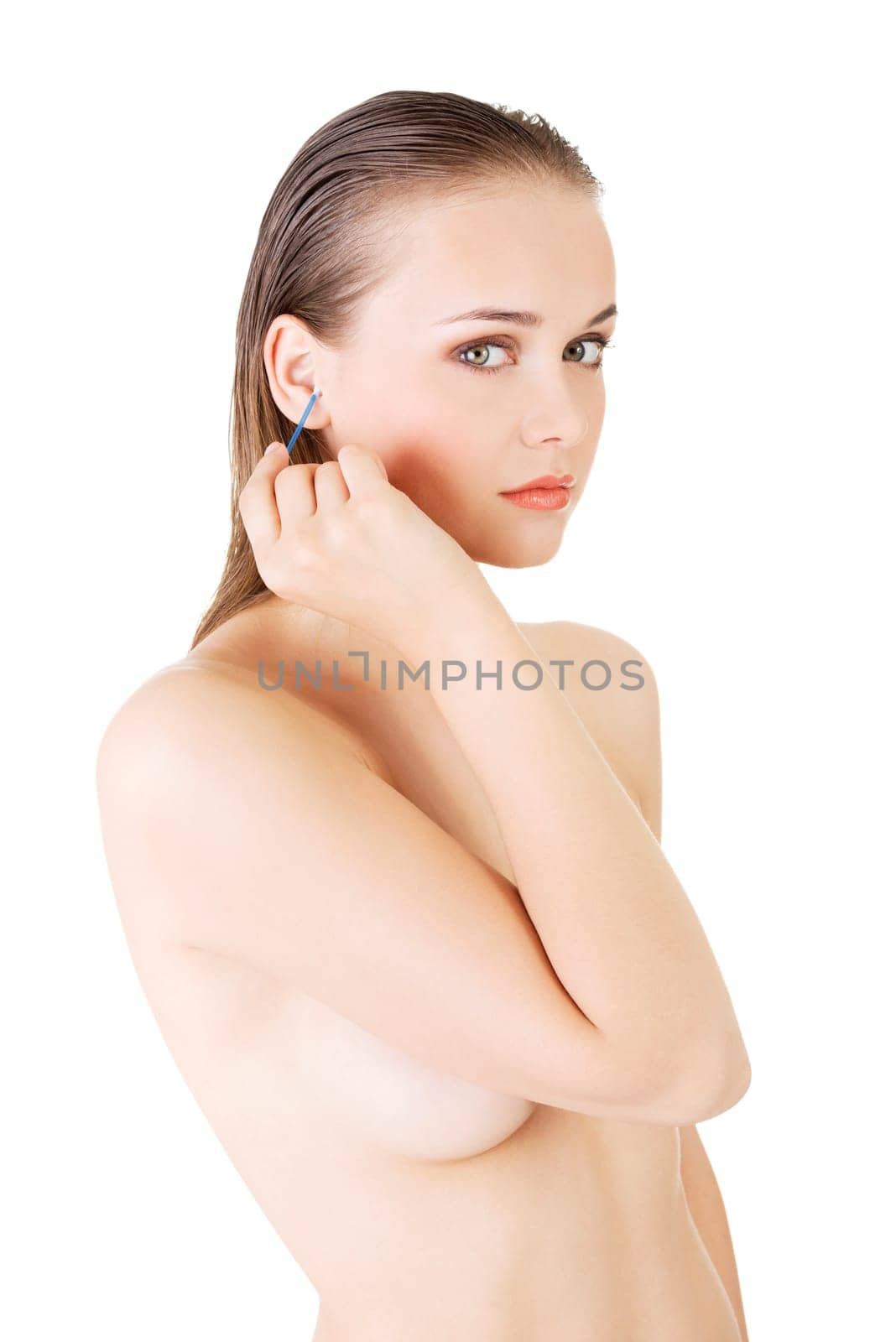 Woman face closeup while cleaning up an ear with a swab, over white.