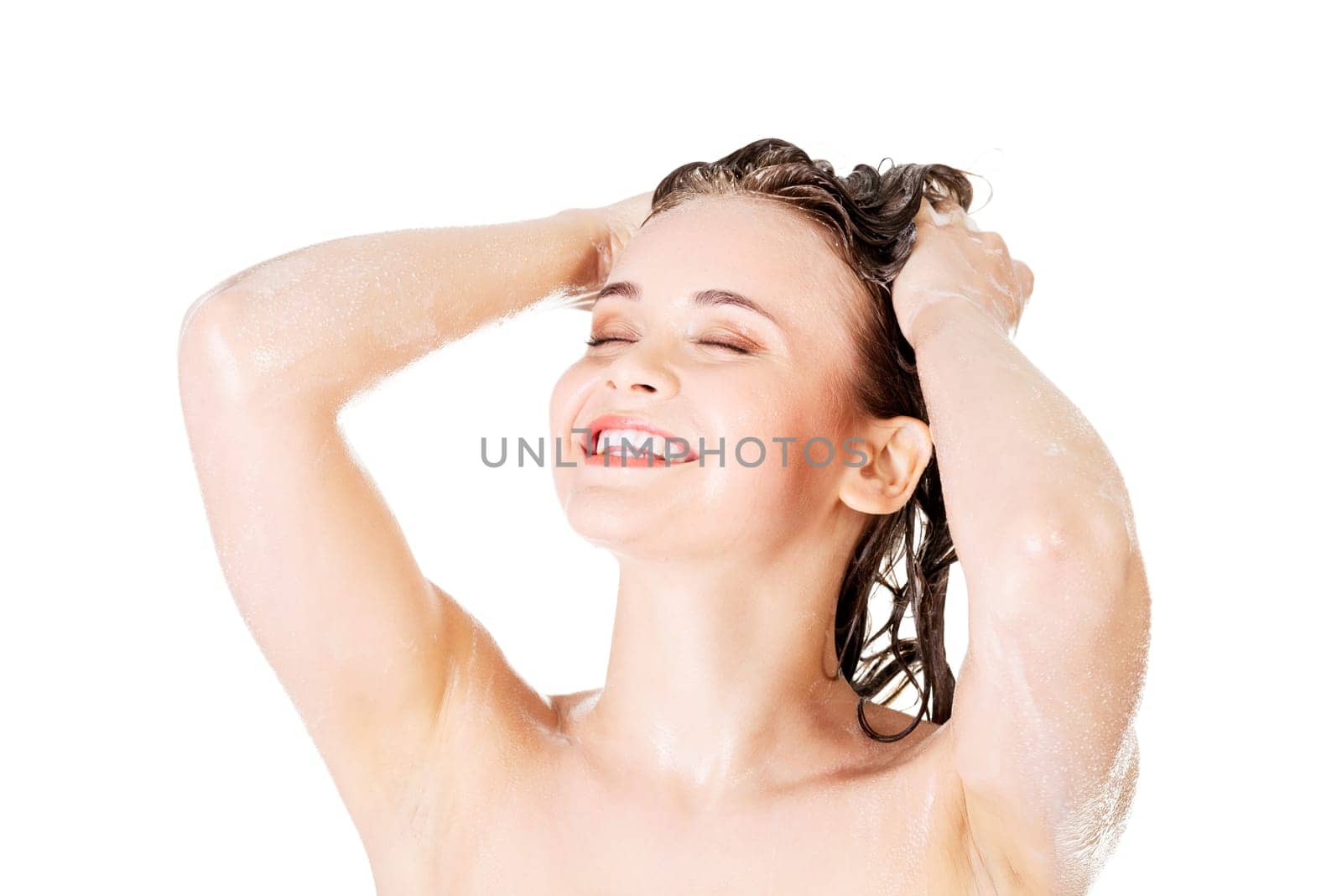 Young fit woman in shower washing her body