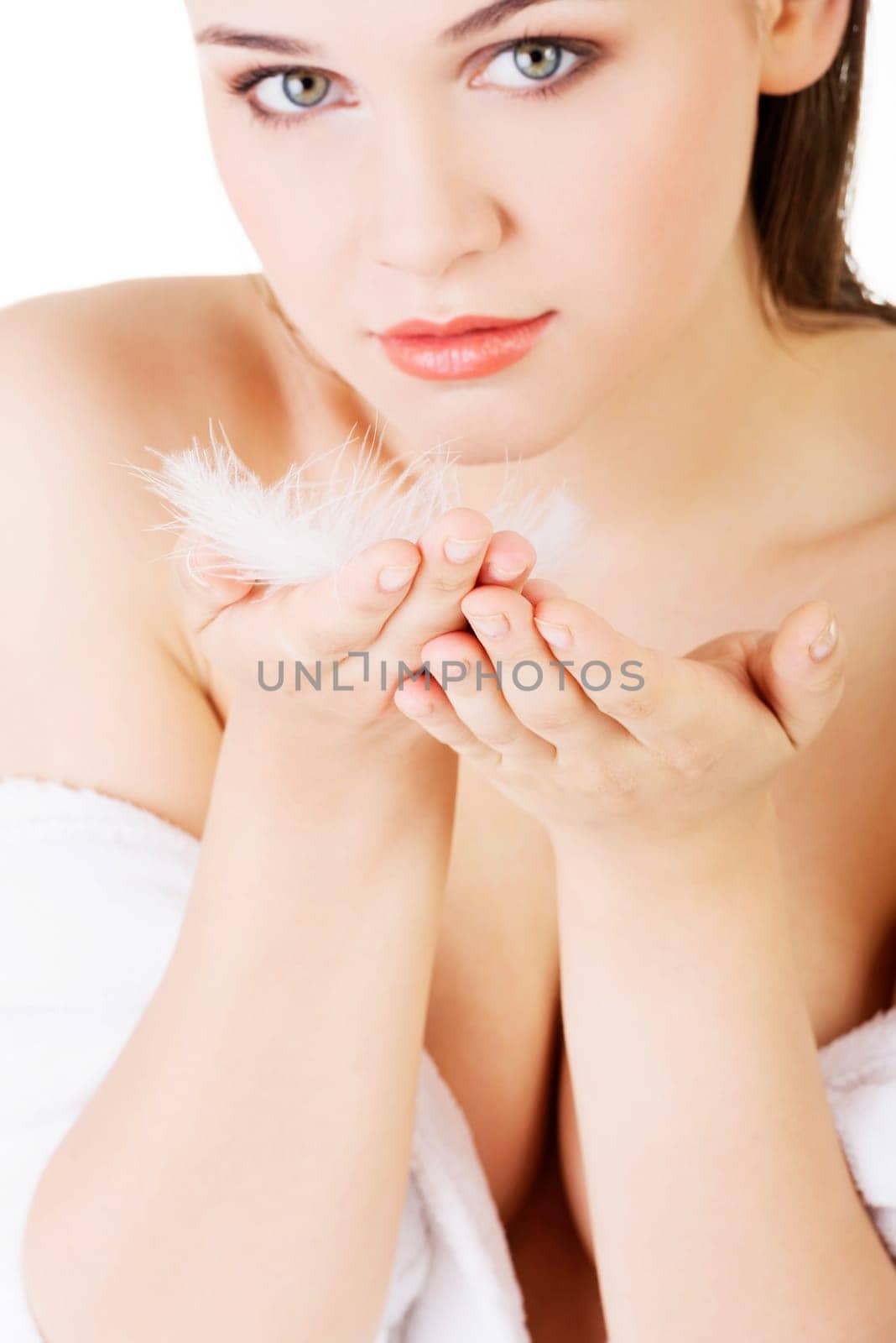 Beautiful woman with white feather. Delicacy concept