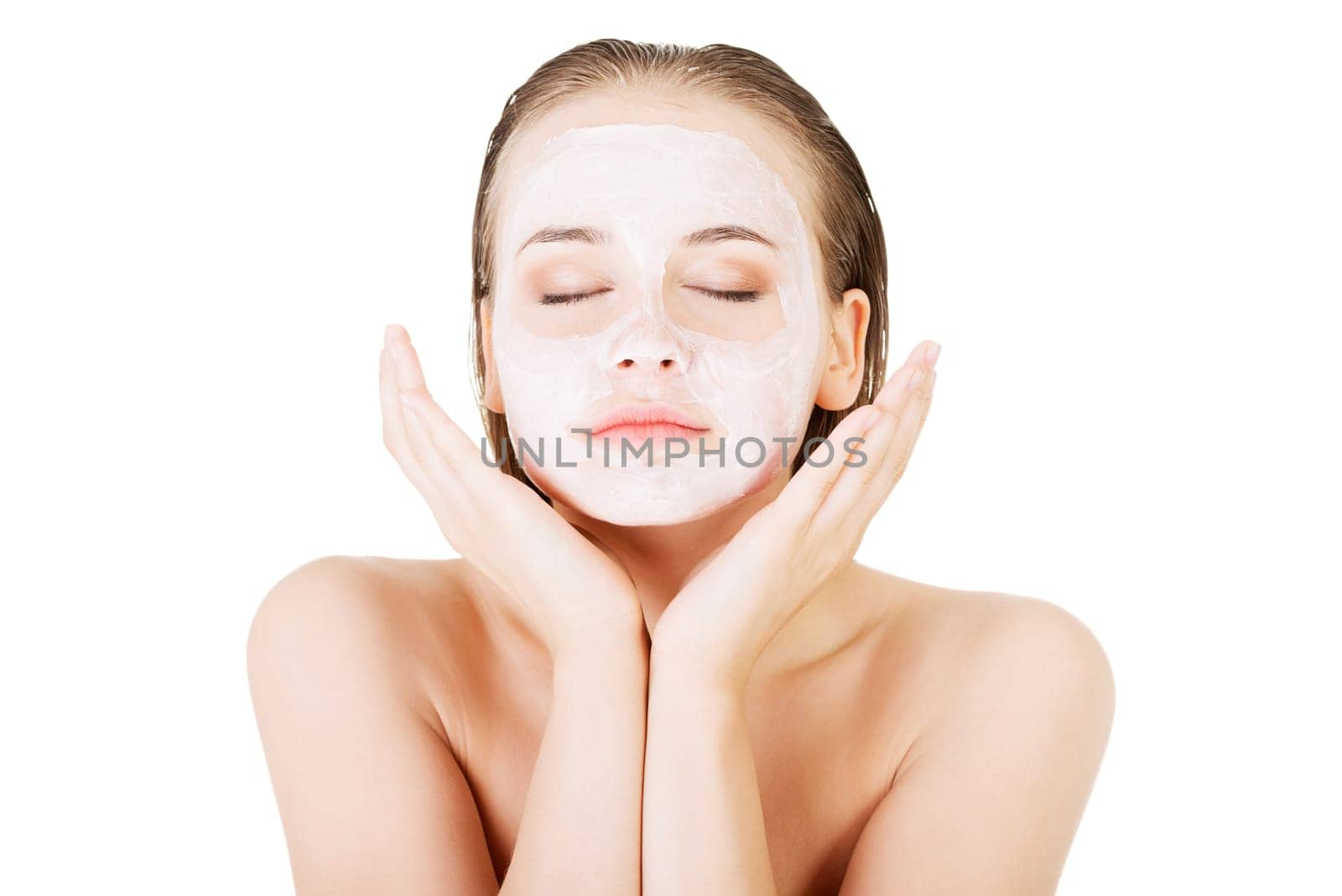 Beautiful woman with clay facial mask, isolated on white