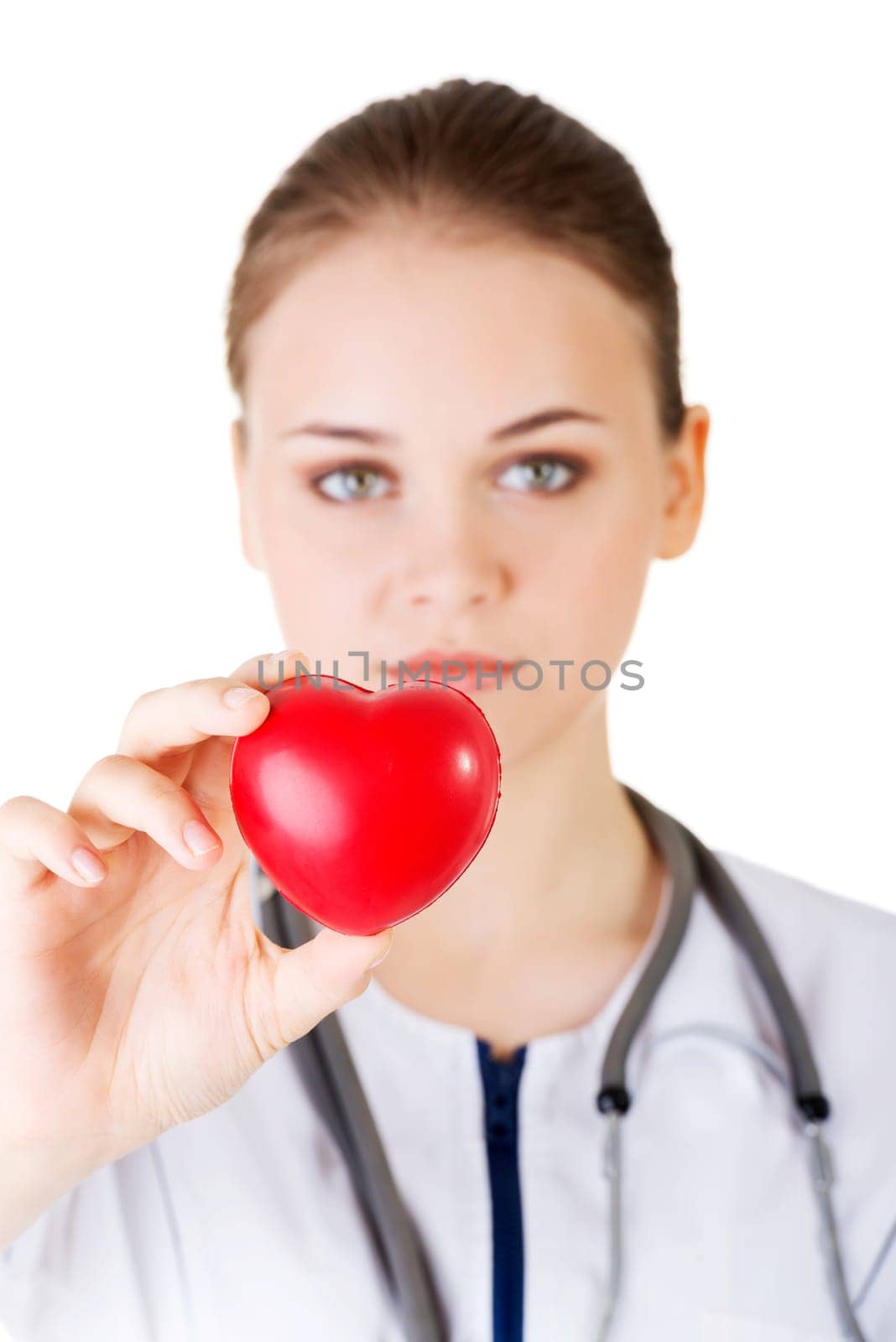 Female doctor holding red heart in hand. Isolated on white background