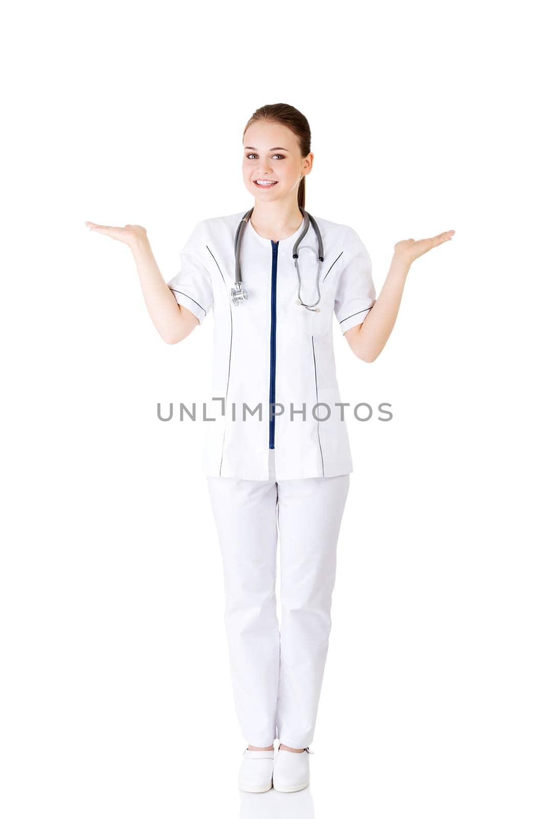 Medical doctor woman or nurse presenting and showing copy space for product or text, isolated on white background