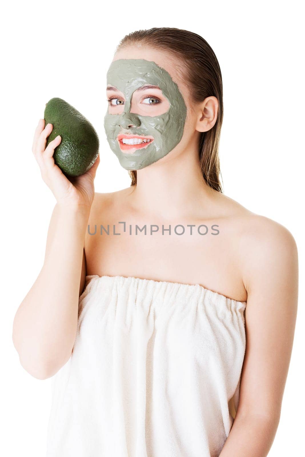 Beautiful woman with green avocado clay facial mask, isolated on white