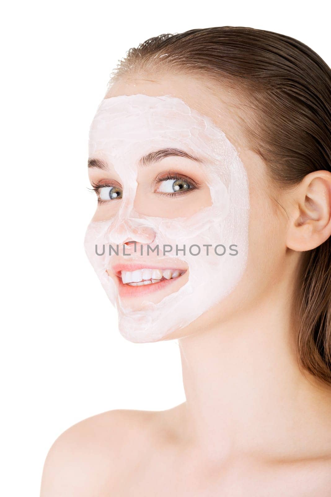 Beautiful woman with clay facial mask, isolated on white