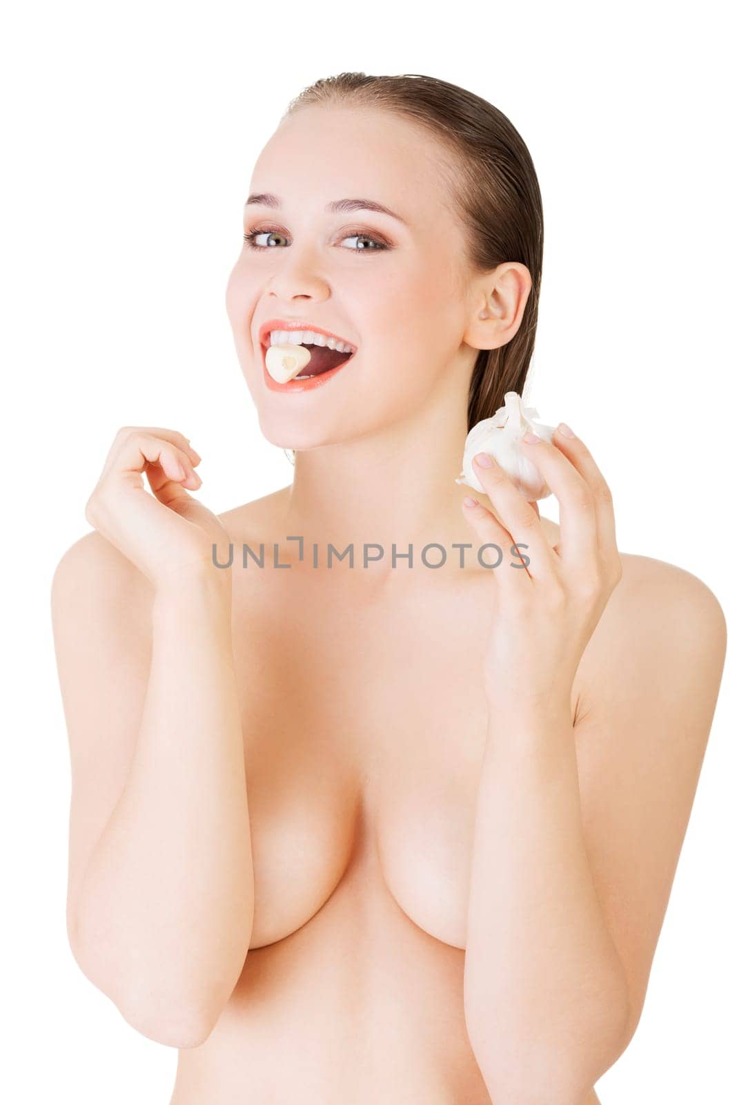 Young beautiful woman eating garlic. Healthy eating concept. Natural antibiotic that fight infection
