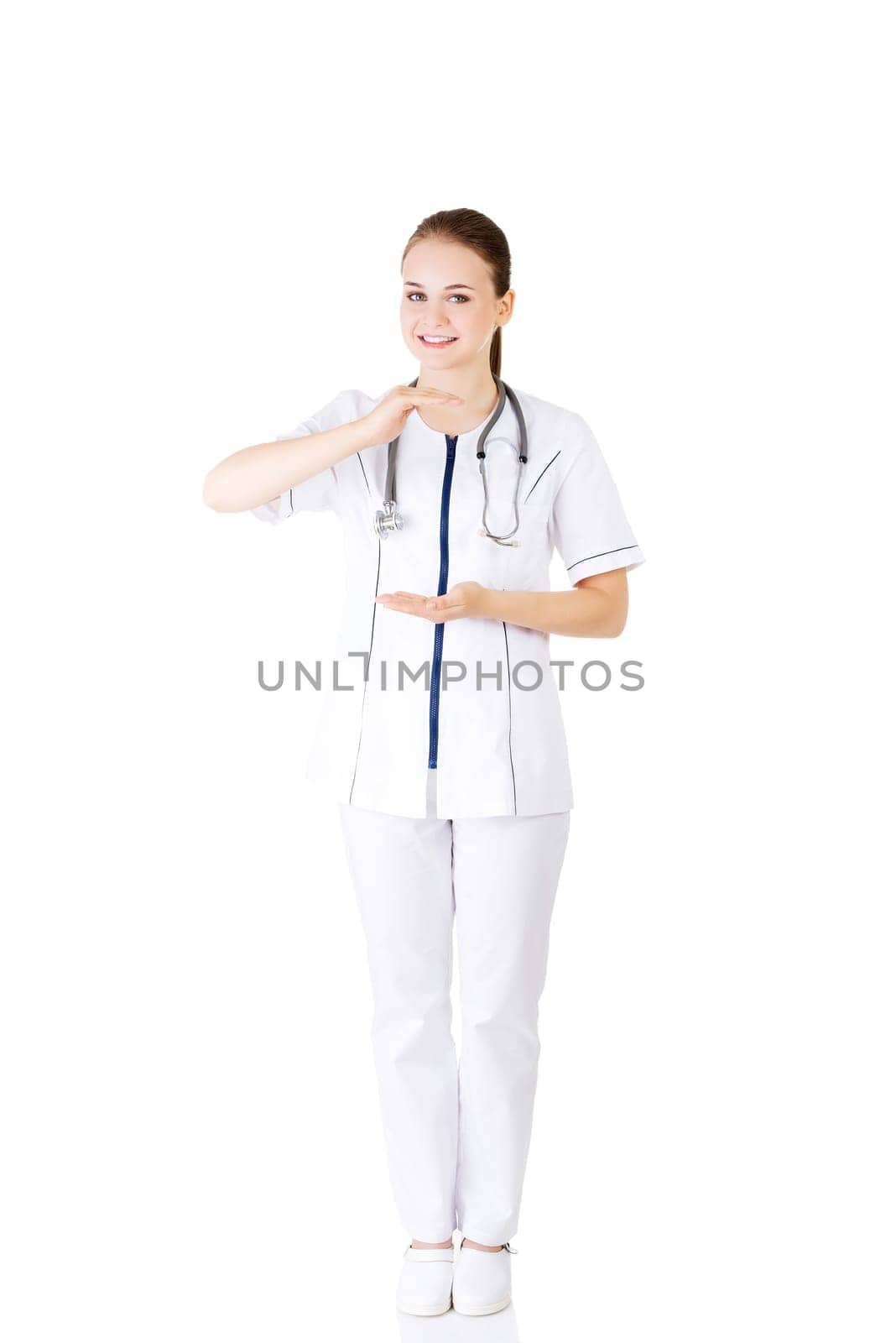 Medical doctor woman or nurse presenting and showing copy space for product or text, isolated on white background