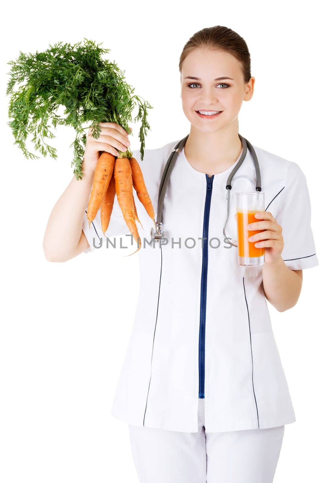 Female doctor holding healthy carrots and juice. Isolated on white.