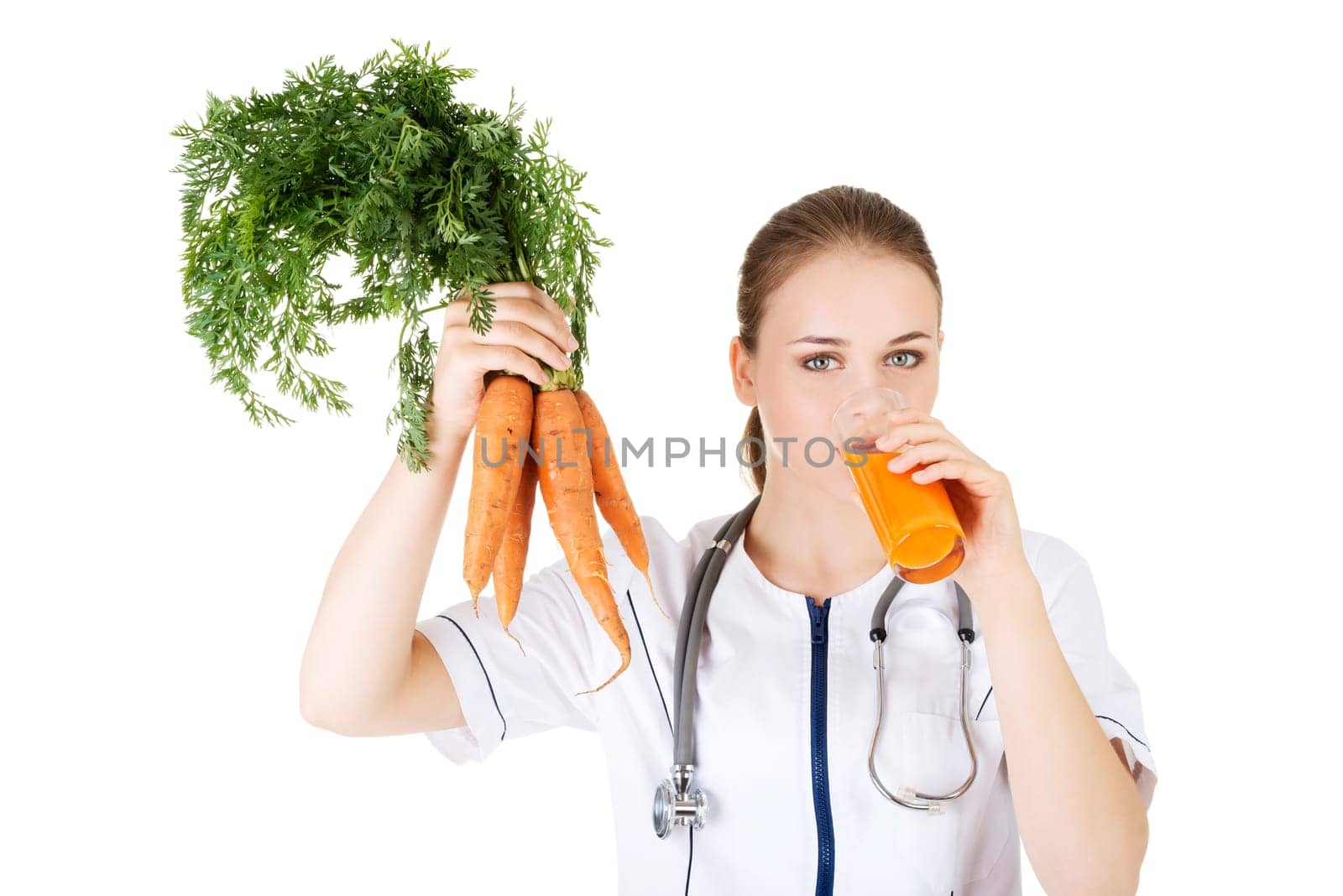 Female doctor holding healthy carrots and juice. Isolated on white.
