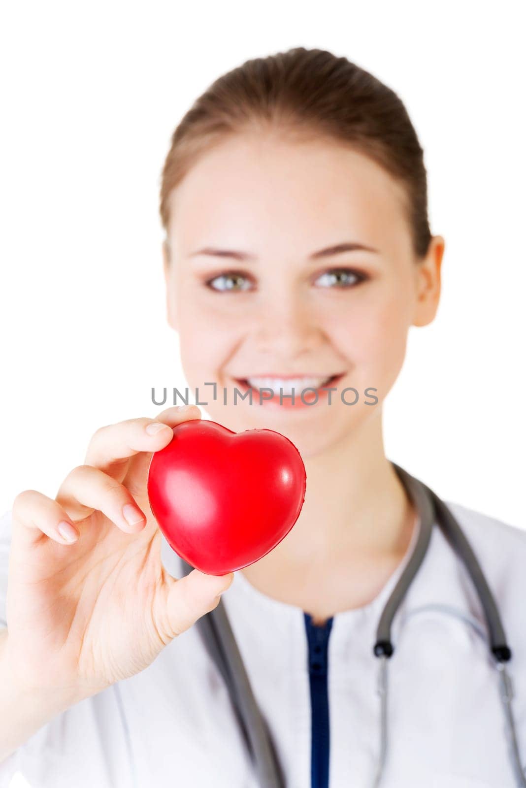 Female doctor holding red heart in hand. Isolated on white background