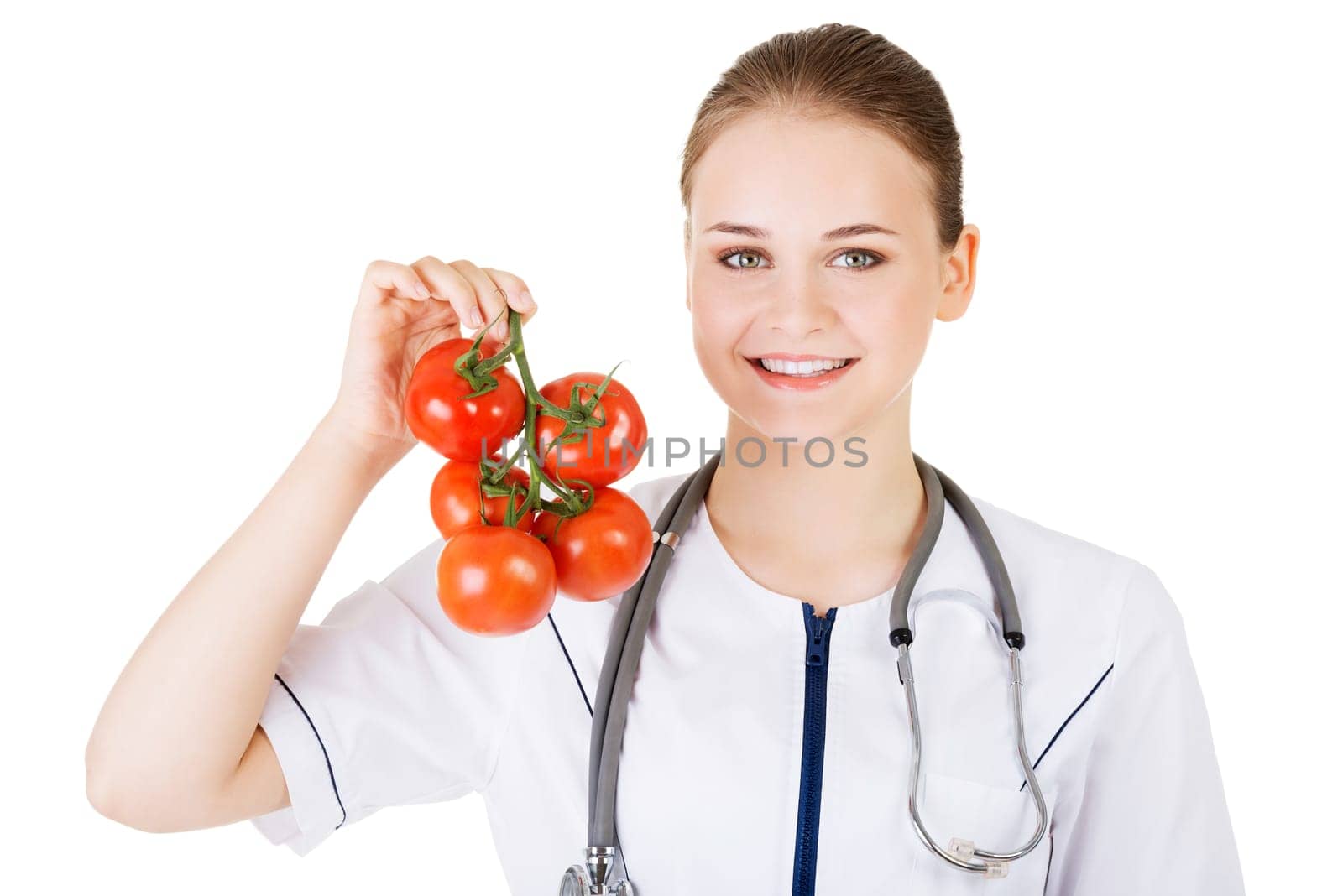 Female doctor holding healthy tomatoes. Isolated on white.
