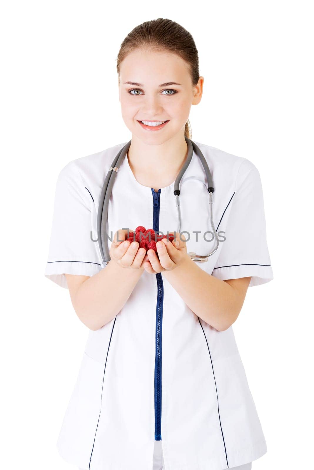 Healthy raspberries. Female doctor holding raspberries in hand.