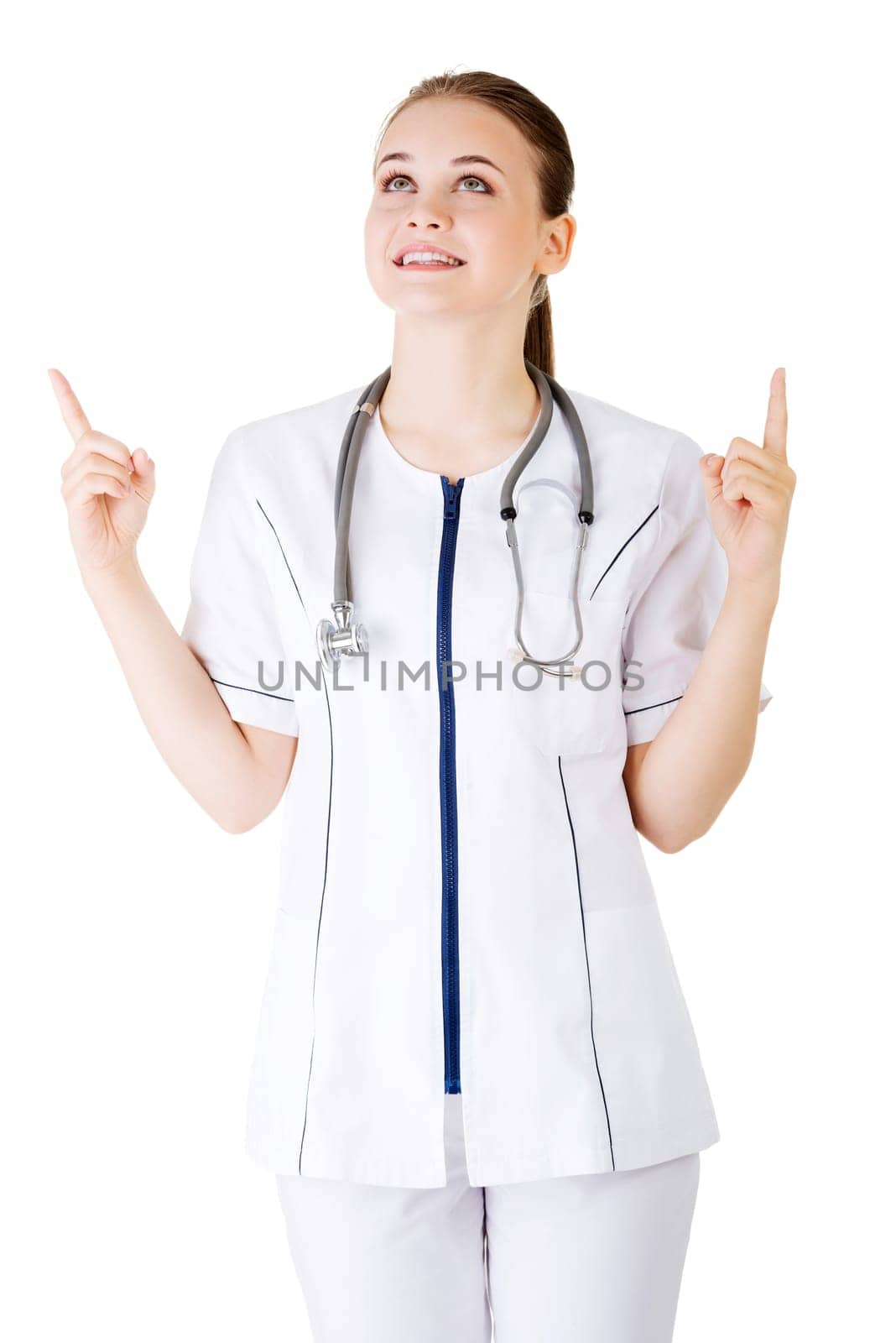 Woman doctor or nurse pointing on copy space. Isolated on white