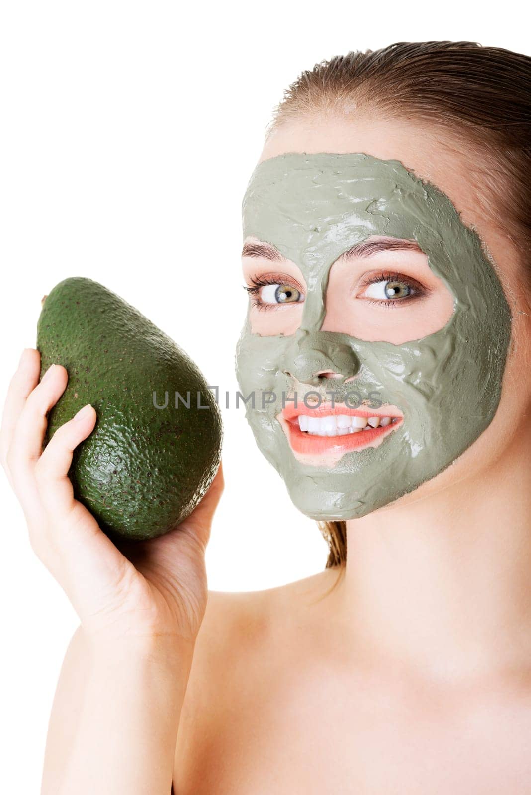Beautiful woman with green avocado clay facial mask, isolated on white