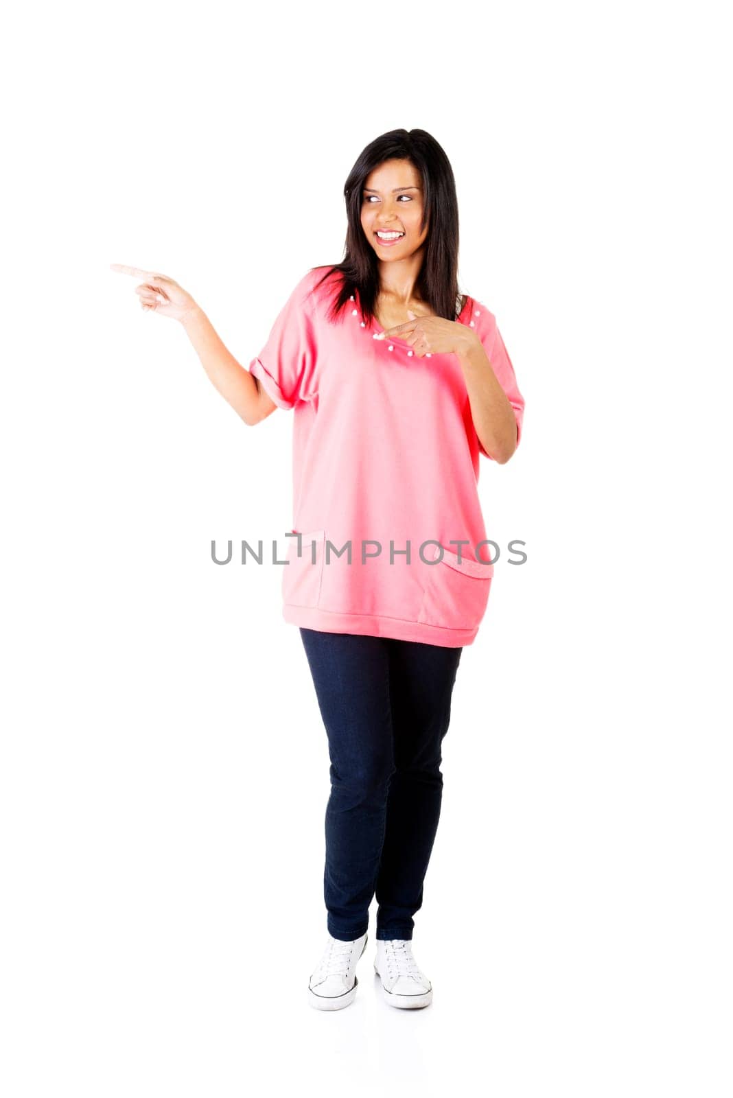 Happy , excited young woman pointing on copy space, isolated on white