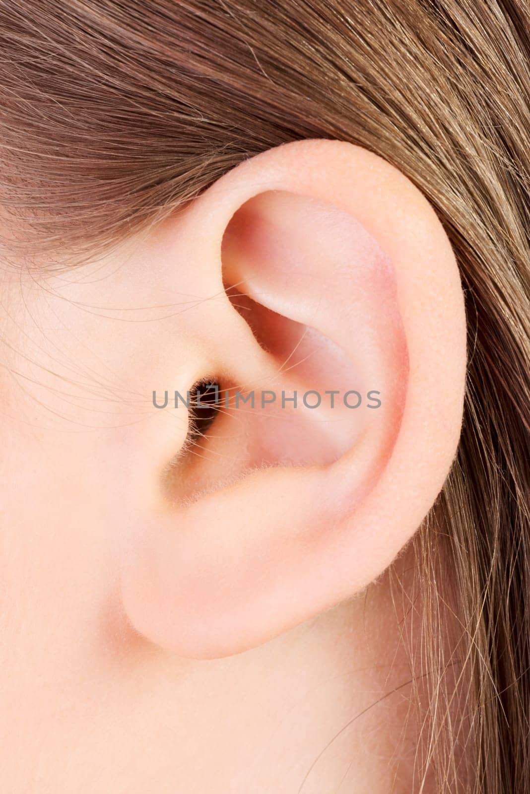 Young caucasian woman ear closeup.