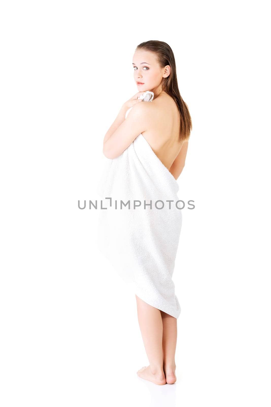 Young beautiful nude woman with towel , isolated on white