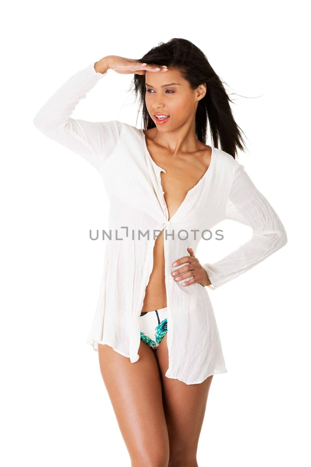 Attractive woman in summer clothes looking away. Isolated on white.