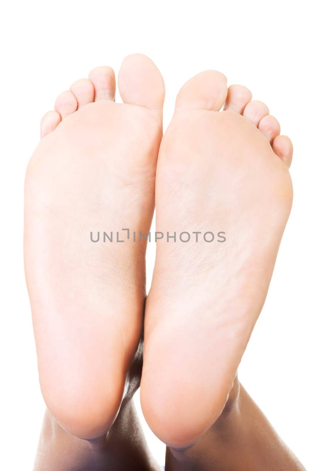 Beautiful female a foot and a heel lifted upwards on a white background