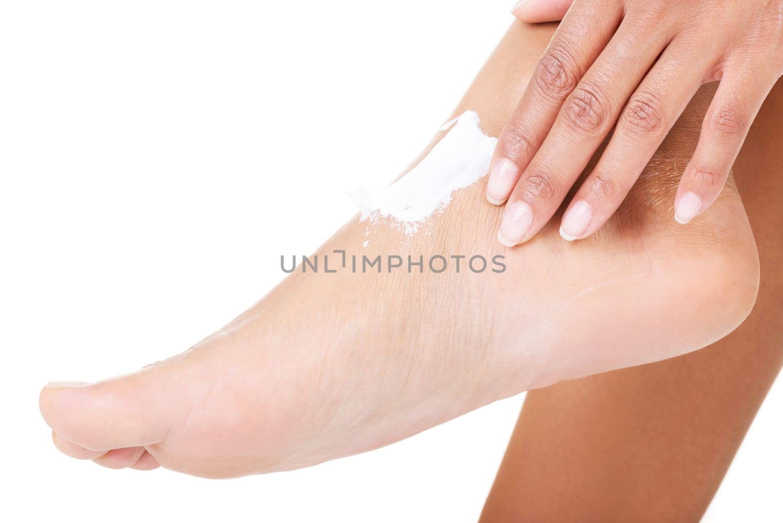 Female hands treating feet with moisturizing cream, isolated on white