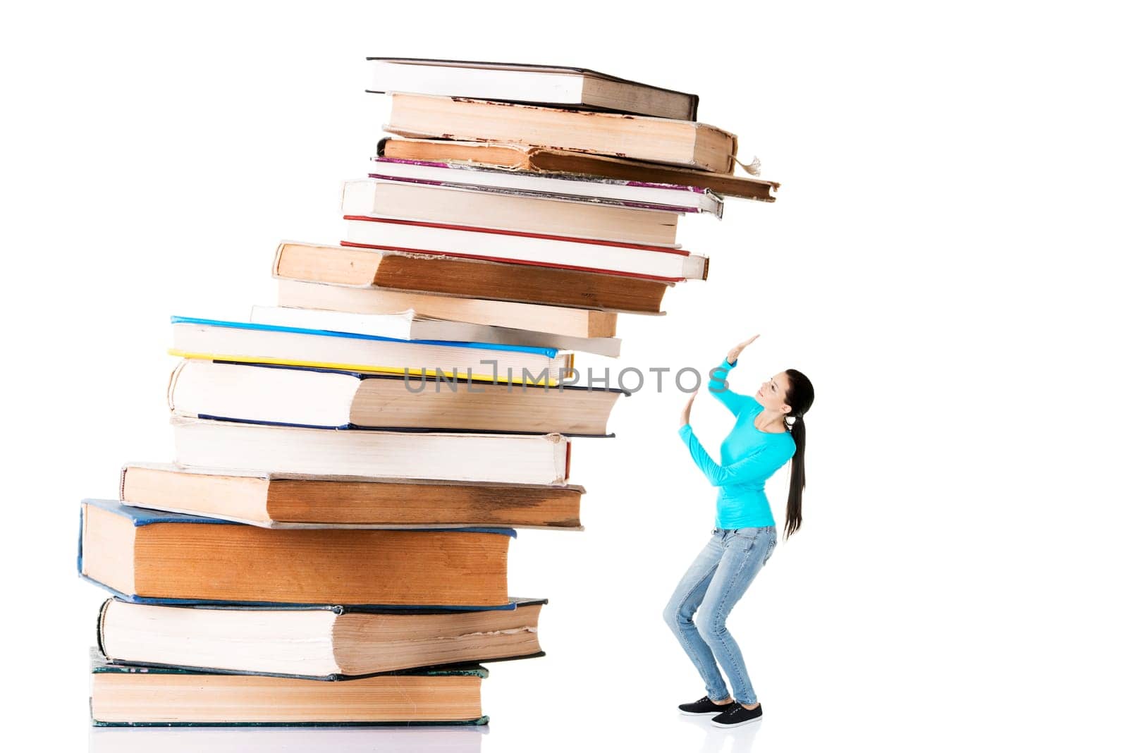 Student woman afraid of pile of books. Isolated on white background. Learning problem and exam concept.