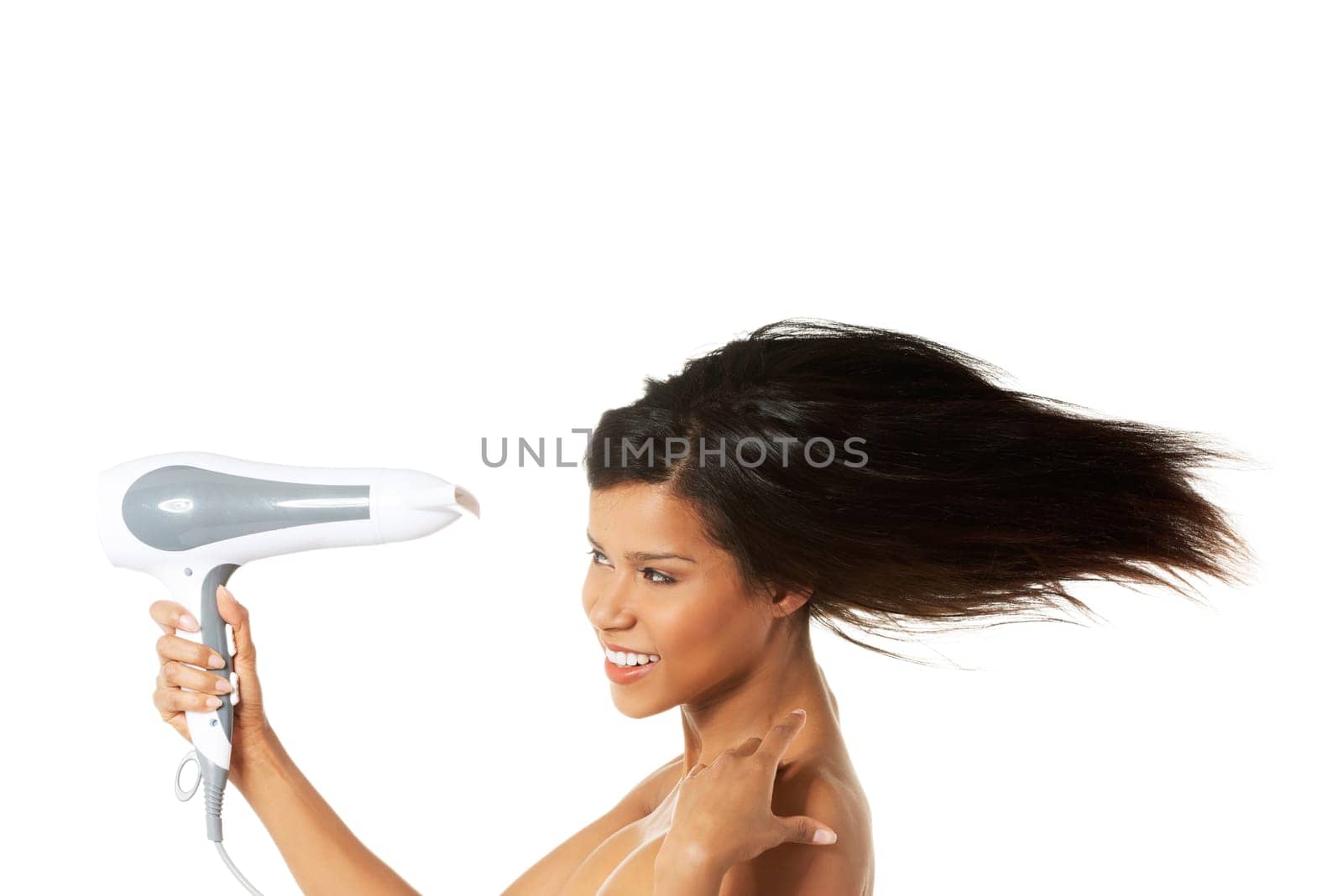 Woman with long hair holding strong blow dryer