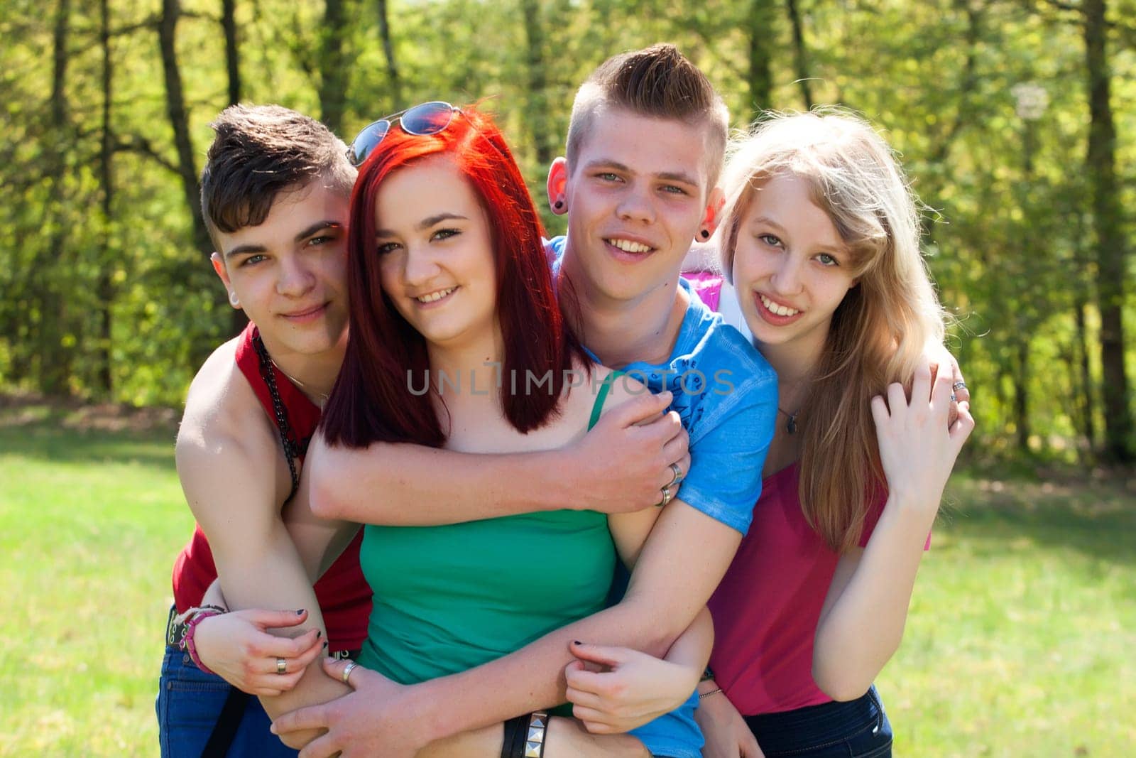 Young teenage group with colored shirts are having fun