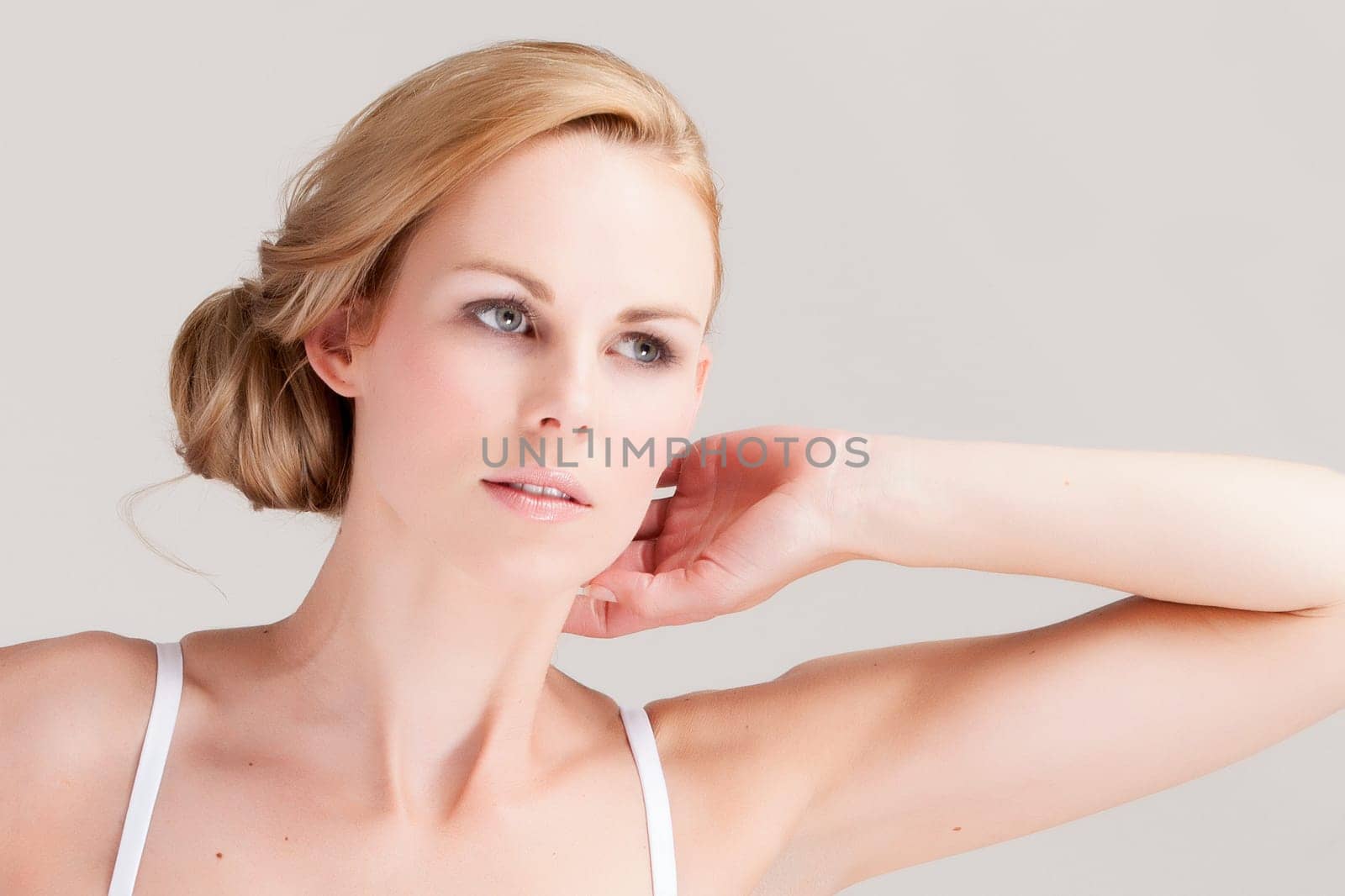 Beautifull young blond woman in the studio is relaxing