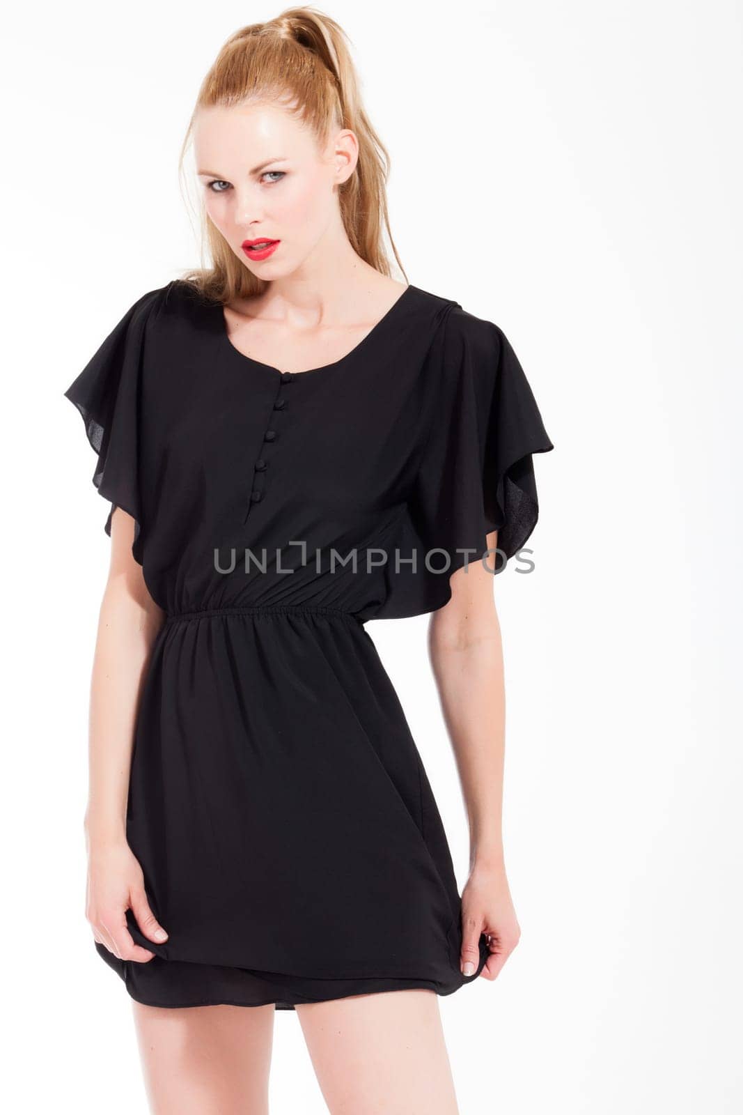Beautifull young blond woman in the studio with a sexy black dress