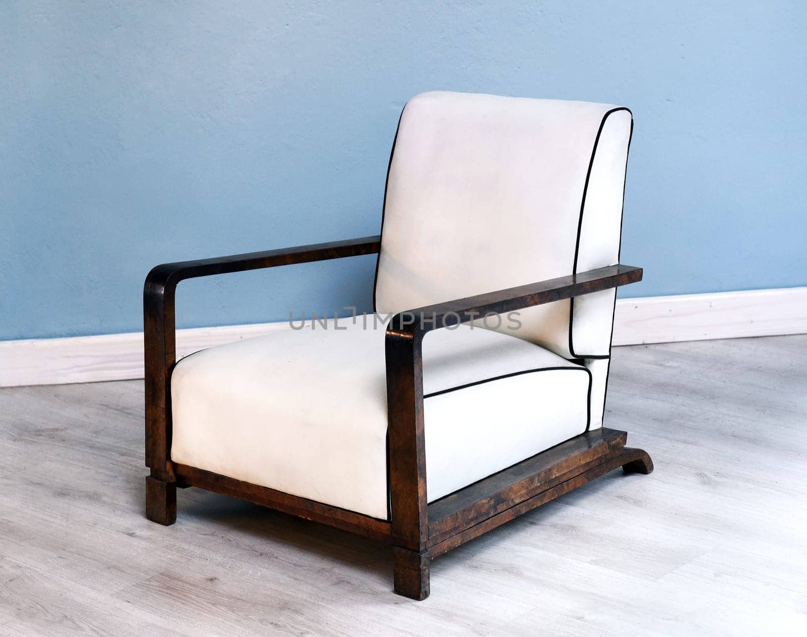 Stylish wooden art deco chair with white upholstery in modern room