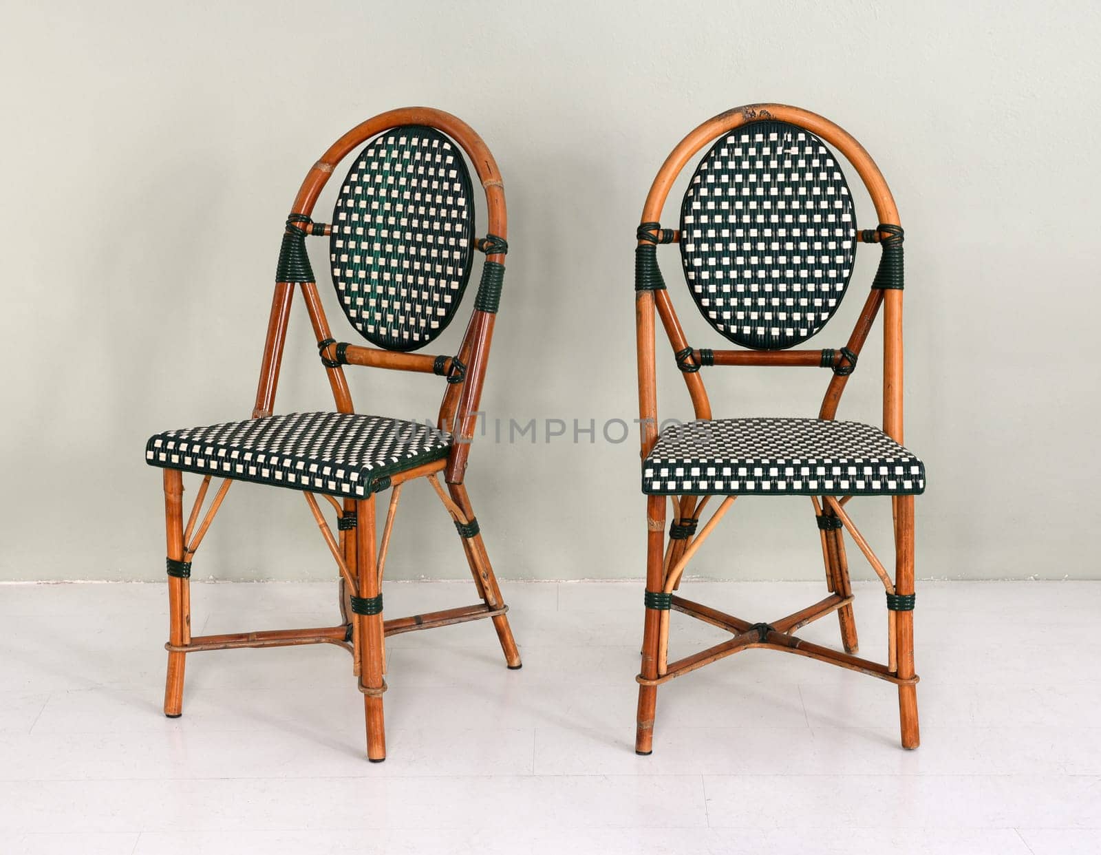 Pair of bamboo chairs with polka dot upholstery in modern room