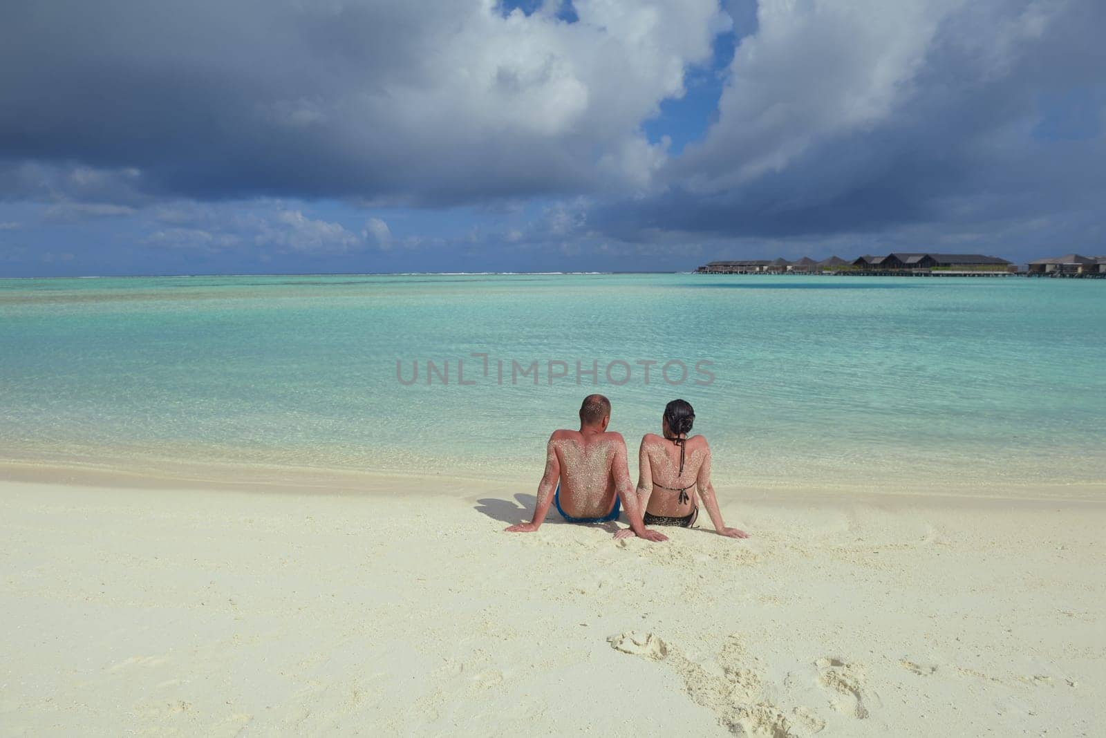 happy young couple have fun and relax at summer vacation on background maldives travel location and beautiful white sand beach