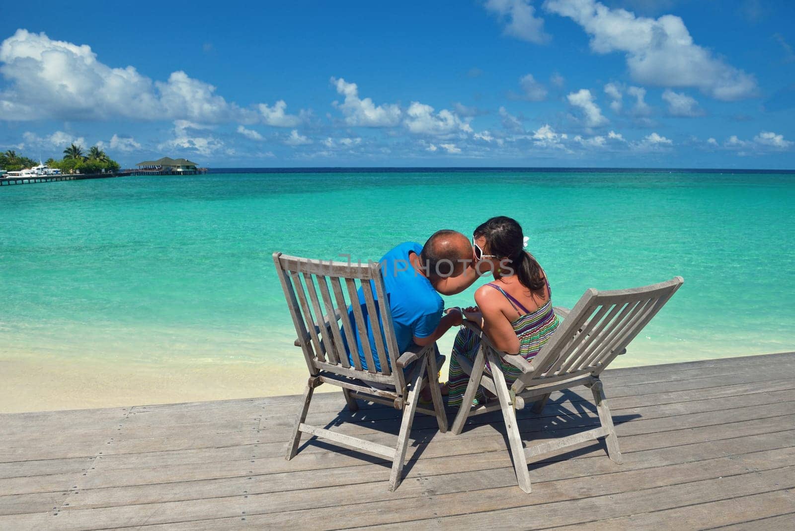 happy young couple have fun and relax at summer vacation on background maldives travel location and beautiful white sand beach