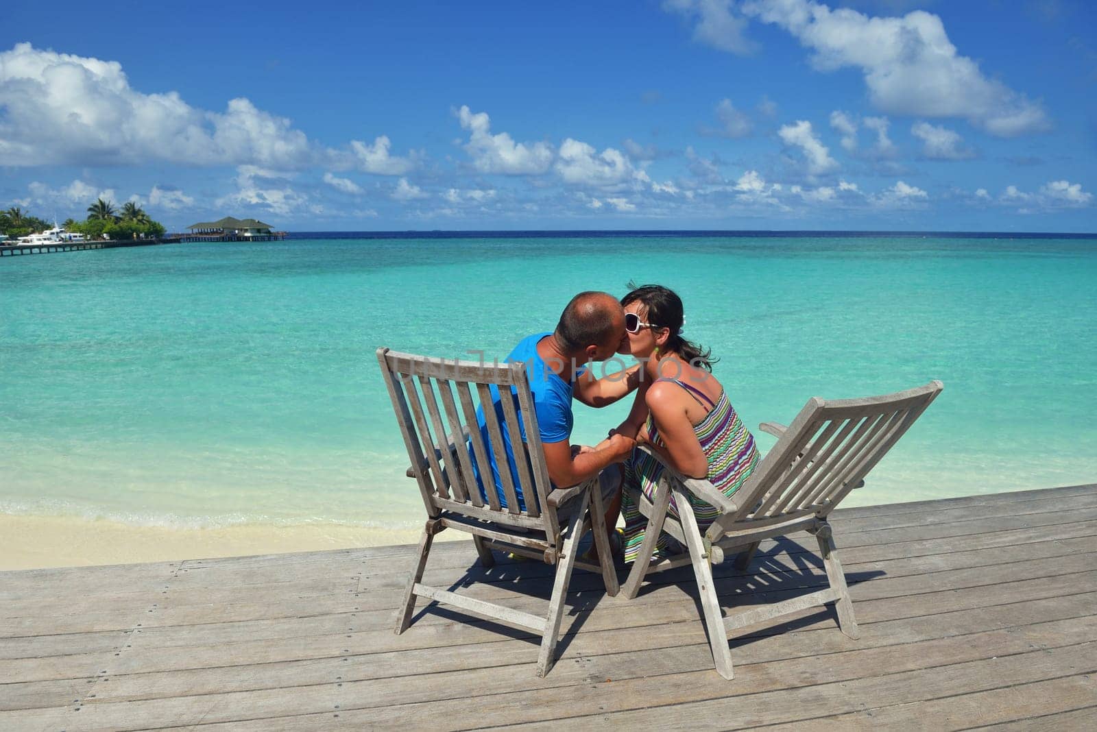 happy young couple have fun and relax at summer vacation on background maldives travel location and beautiful white sand beach