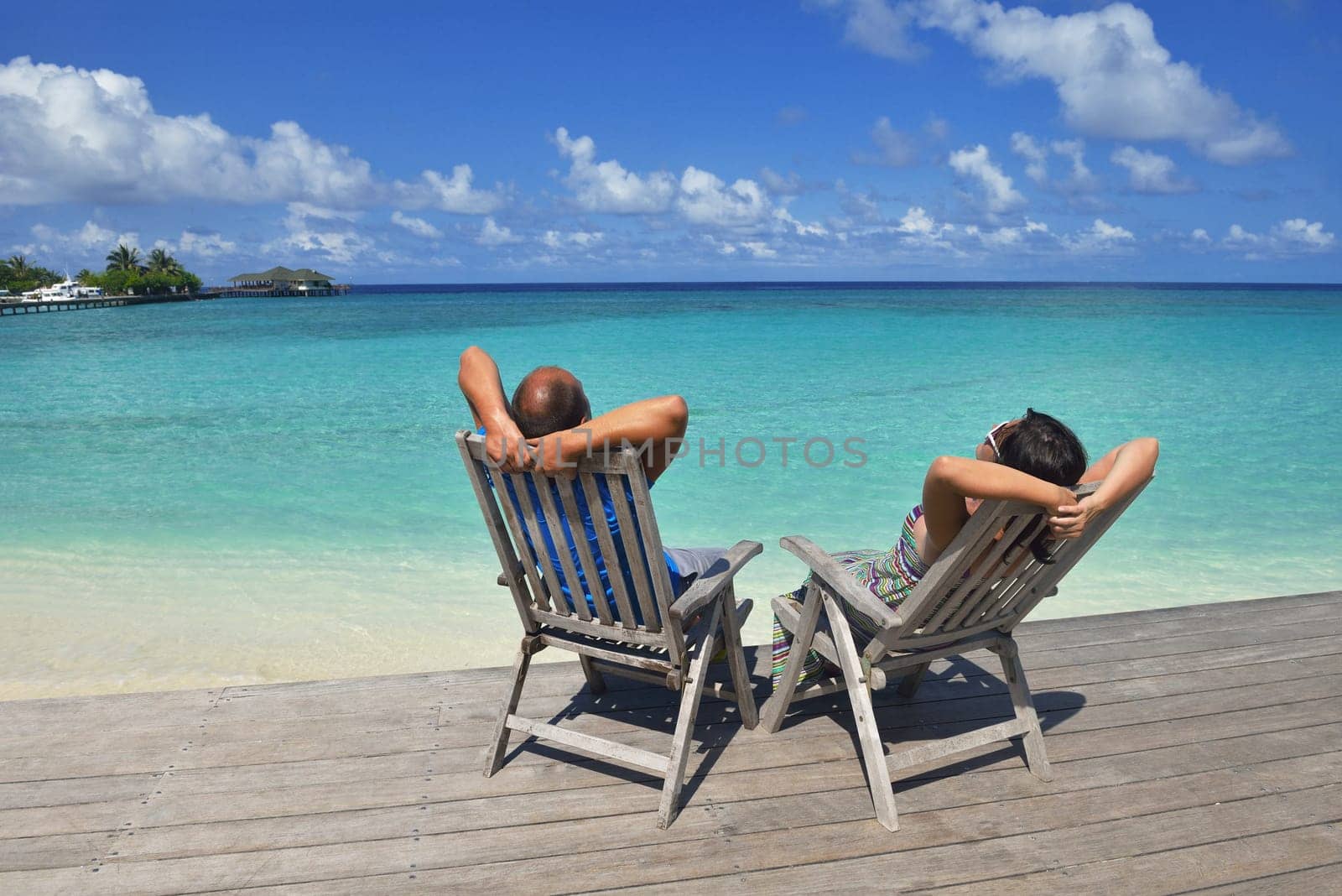 happy young couple have fun and relax at summer vacation on background maldives travel location and beautiful white sand beach