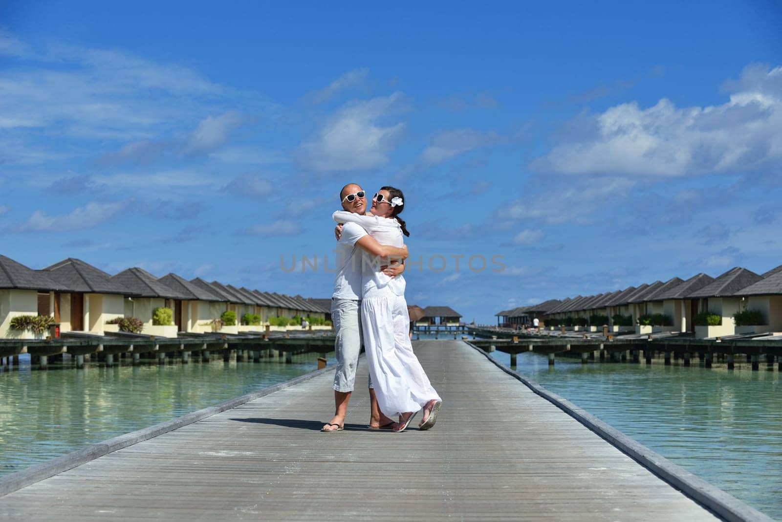 happy young couple have fun and relax at summer vacation on background maldives travel location and beautiful white sand beach