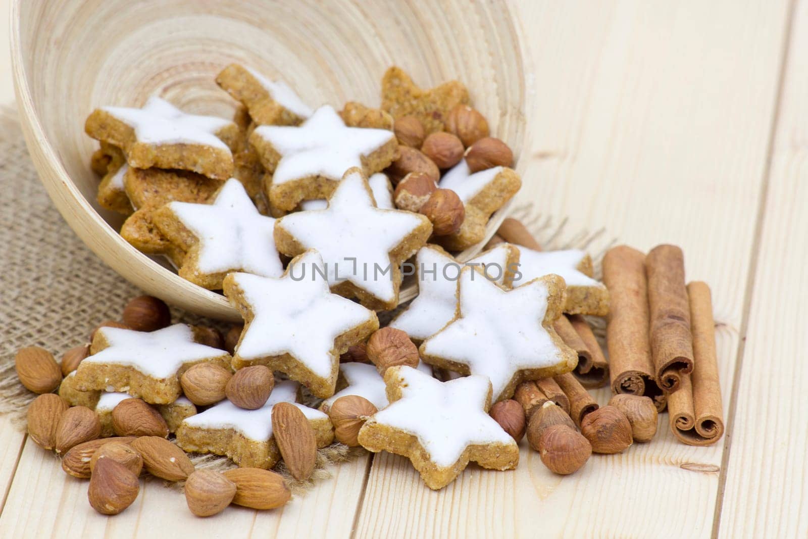 typical christmas cinnamon star cookies, nuts and cinnamon sticks