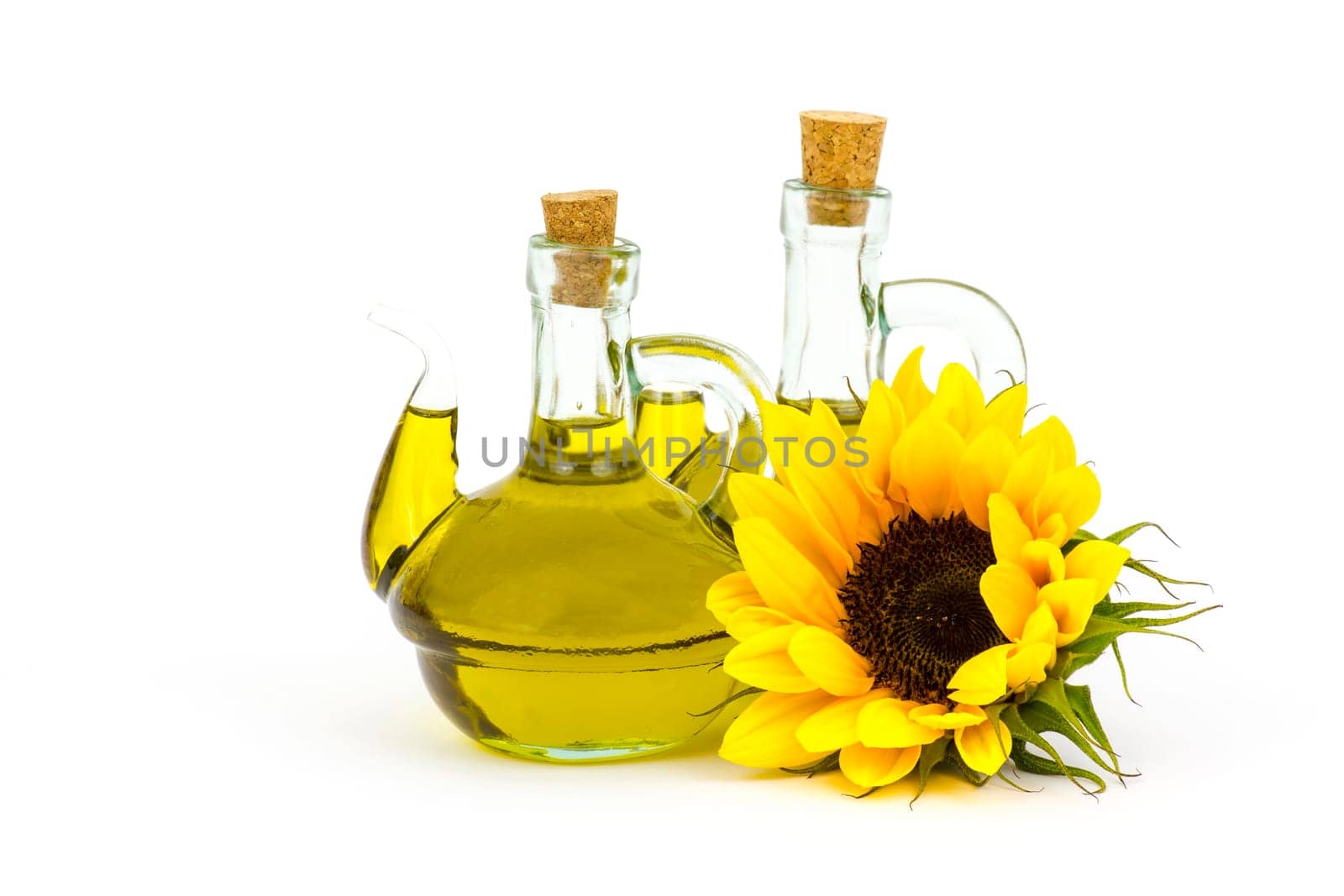 sunflower oil and sunflowers isolated on white background
