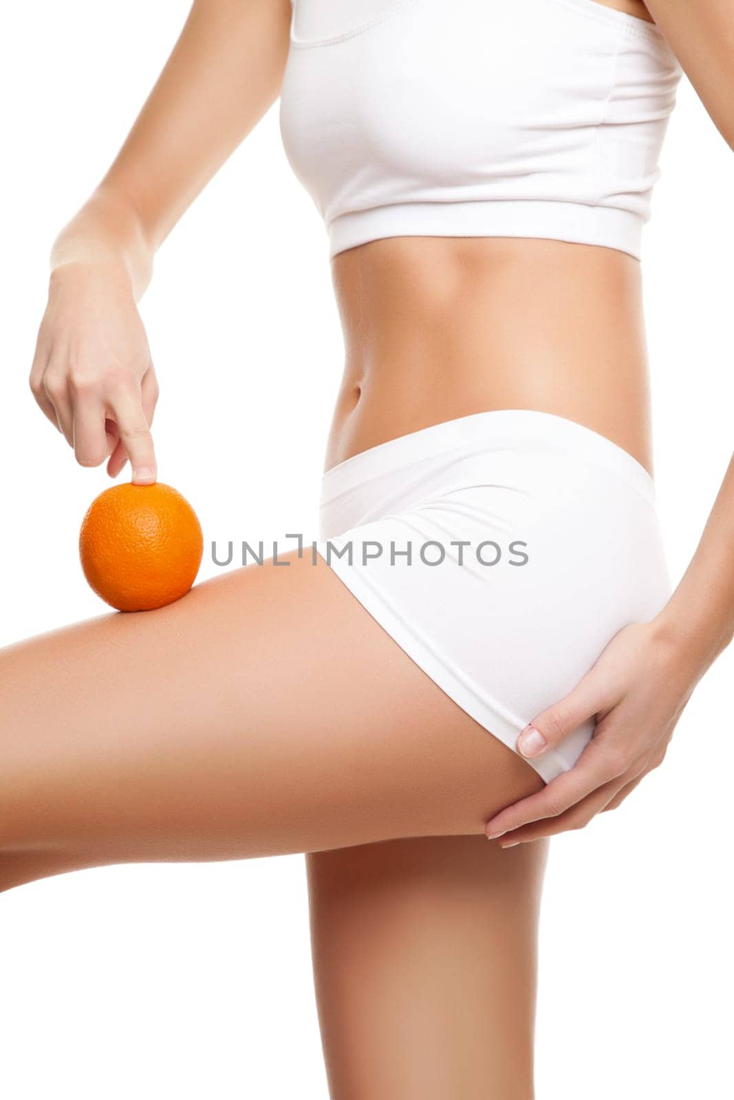 Woman with an orange showing a perfect skin