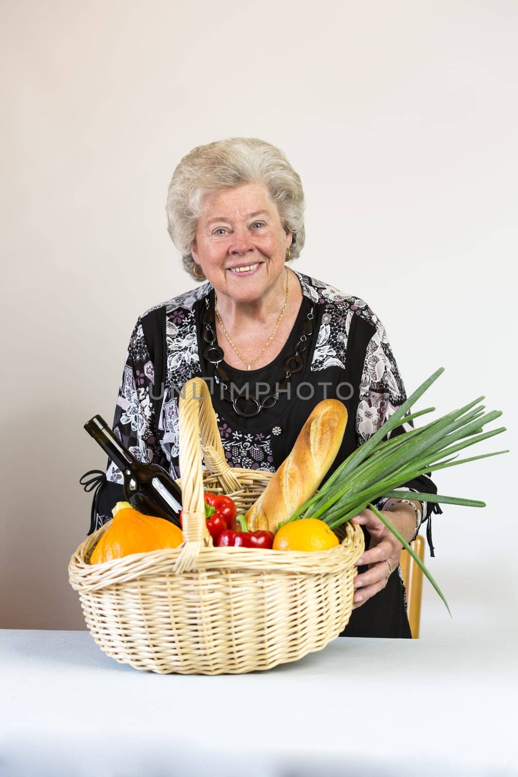 Elderly lady looks at her shopping basket
