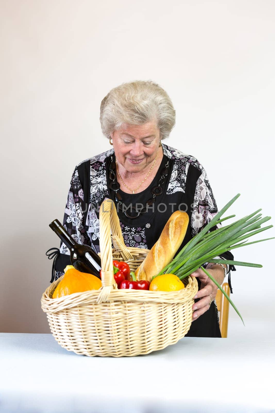 Elderly lady looks at her shopping basket