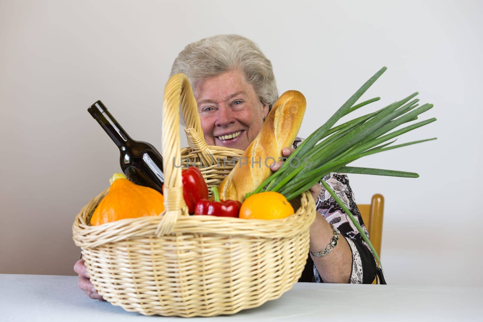 Elderly lady looks at her shopping basket
