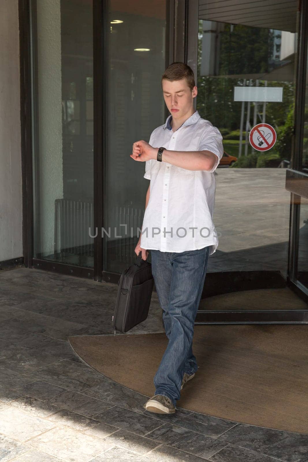 Young man leaves a building