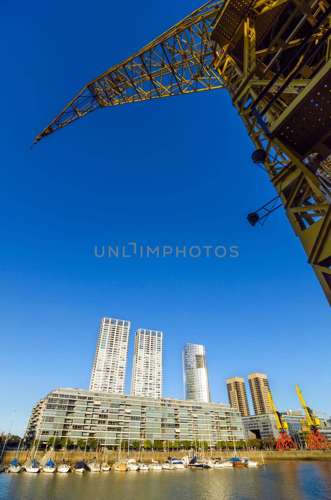 Waterfront of Puerto Madero in Buenos Aires, Argentina with a tall yellow crane rising above