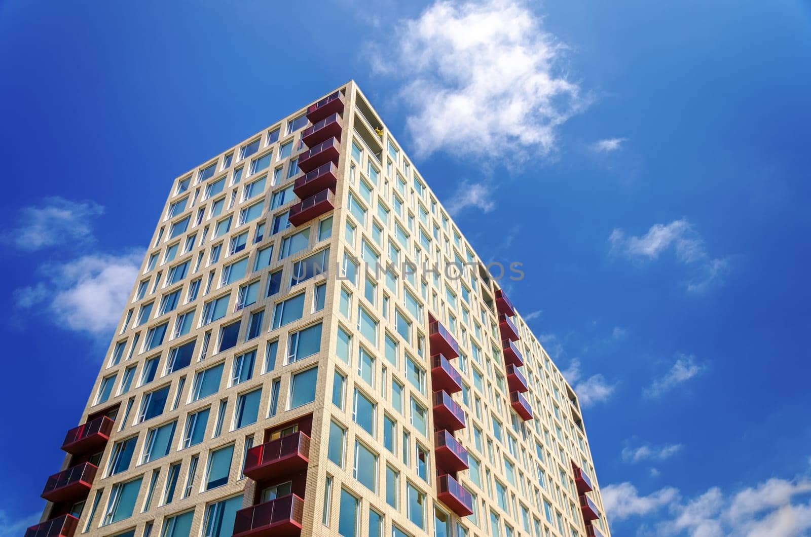 Modern apartment building rising against a beautiful blue sky in Portland, Oregon